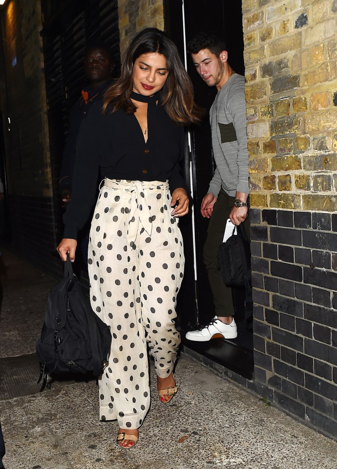 Priyanka Chopra & Nick Jonas walking outside a door