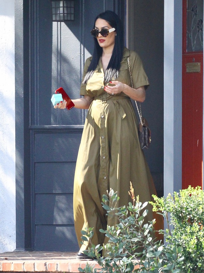 Nikki shows off growing baby bump during a lunch outing