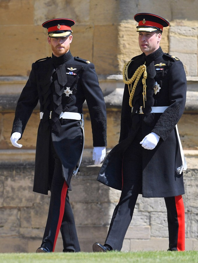 Prince Harry walks outside with Prince William