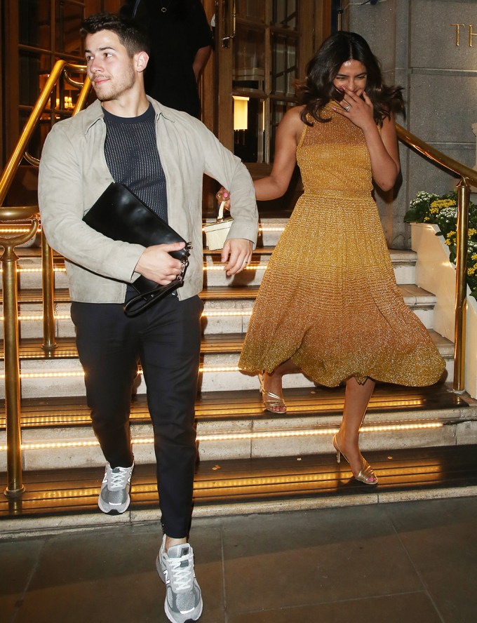 Nick Jonas & Priyanka Chopra walking out of the Ritz Hotel, London