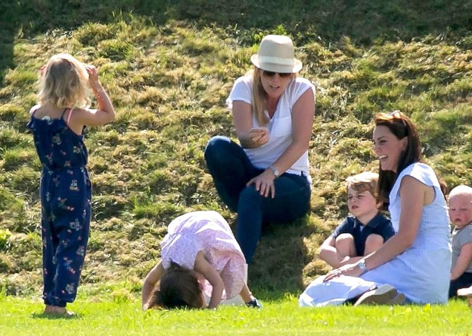Princess Charlotte does a headstand outside