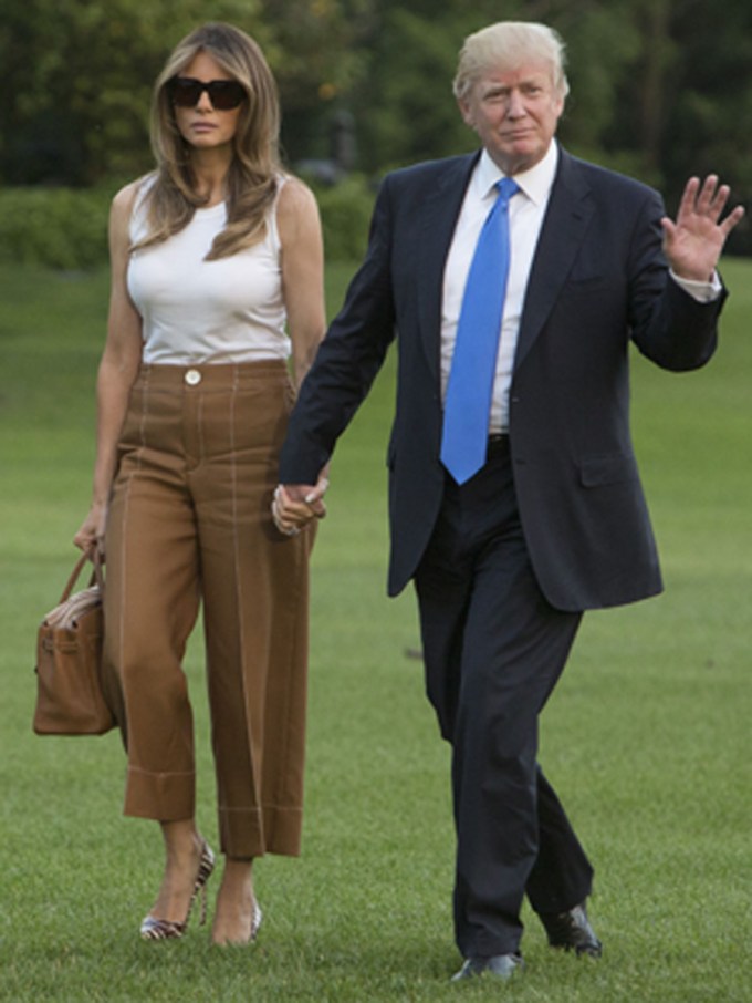 Melania & Donald Tump Holding Hands