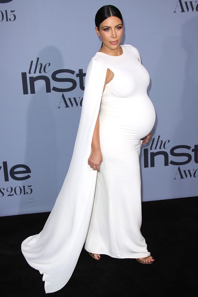 Kim Kardashian in a white dress and cape