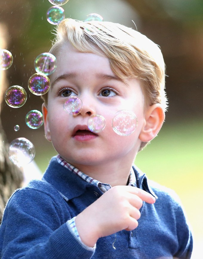 Prince George looks at bubbles
