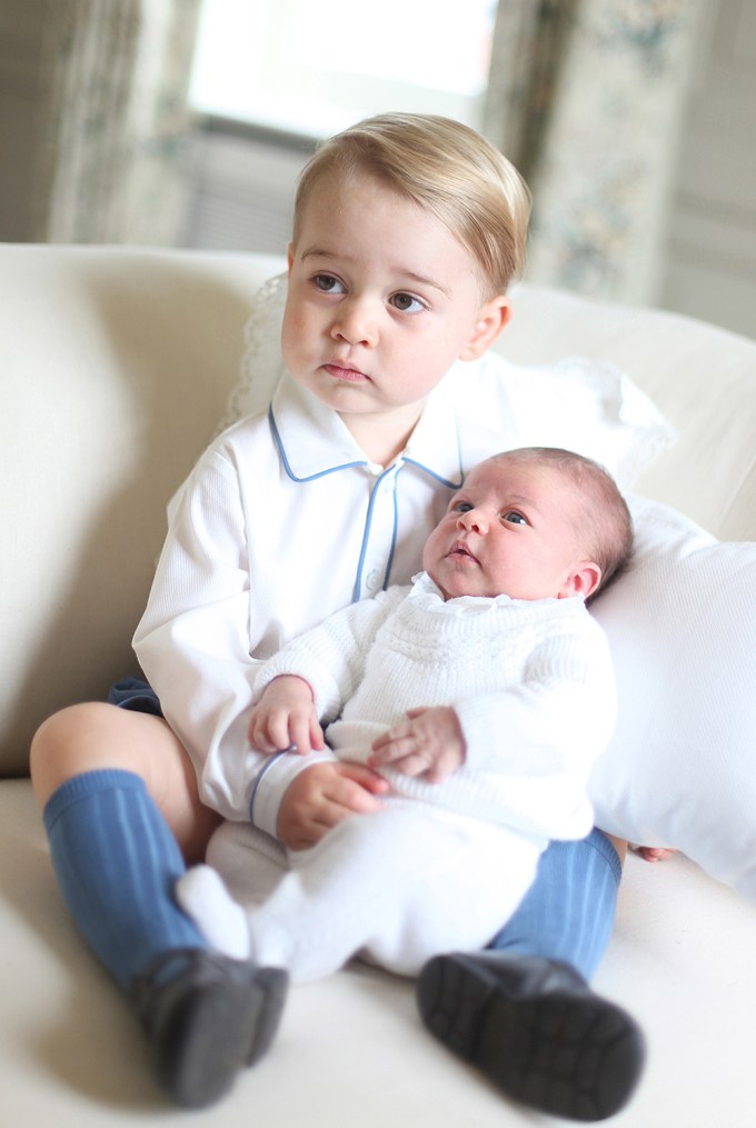 Prince George holds Princess Charlotte