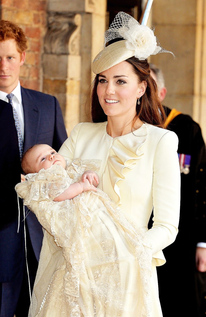 Prince George held by his mother Duchess Catherine