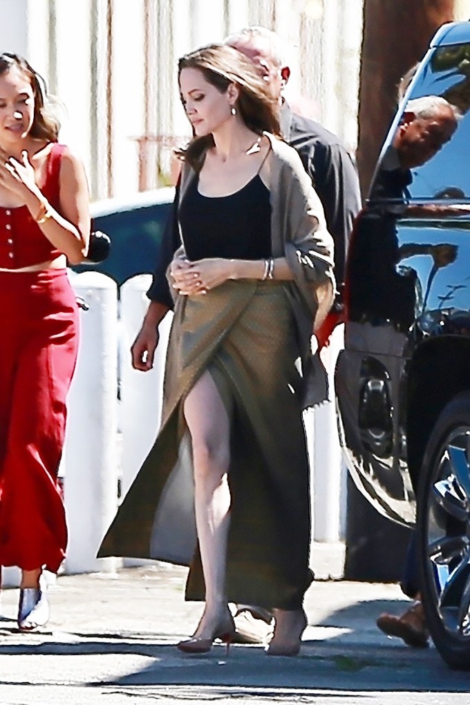 Angelina Jolie showing thigh in a slit skirt
