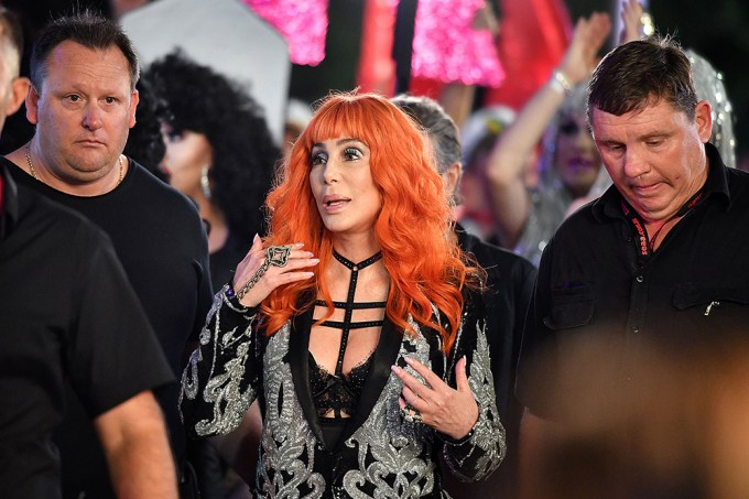Cher looks red-hot in an orange wig