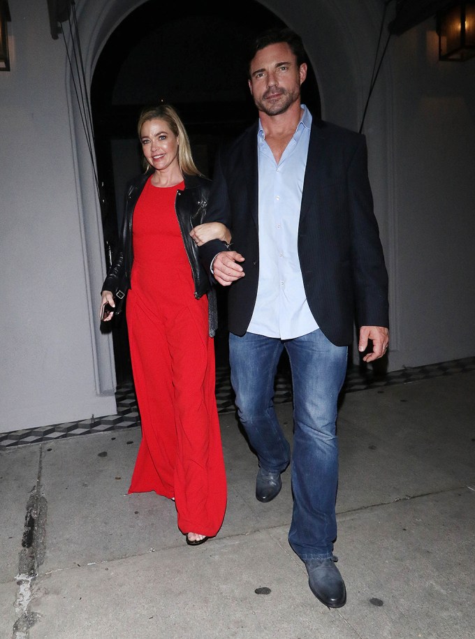 Denise Richards &; Aaron Phypers holding hands