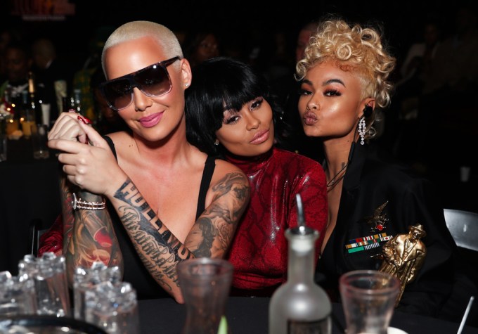 Amber Rose & Blac Chyna posing at a table