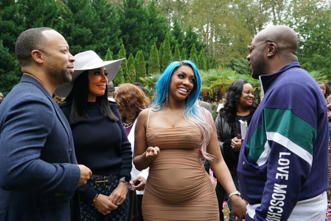 Porsha Williams & Dennis McKinley chat with friends during an outing