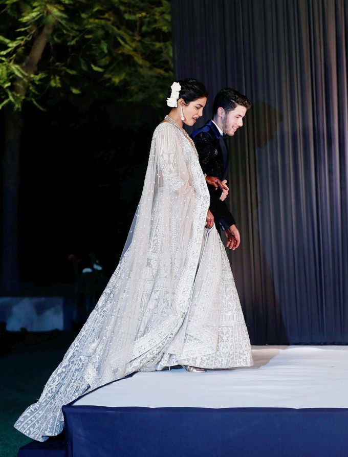 Nick Jonas and Priyanka Chopra walk together following their wedding