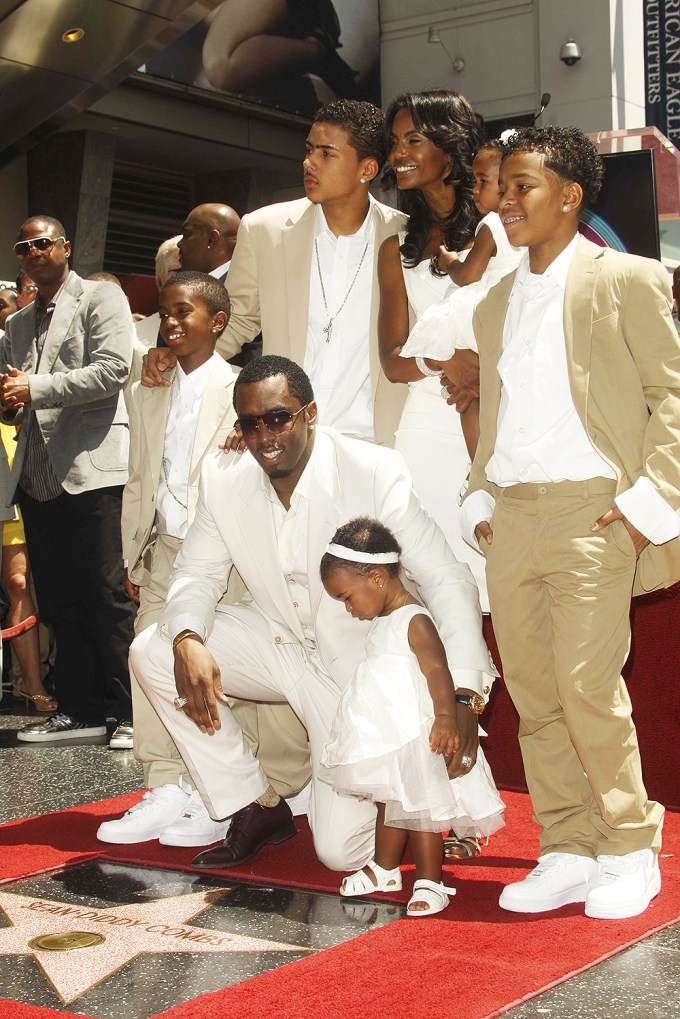 Kim Porter smiles with Sean Combs and their kids in Hollywood