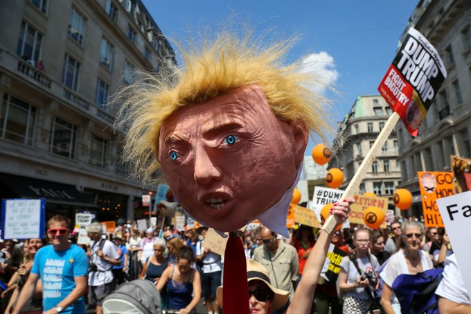 A Protestor Holds Up A Donald Trump Head