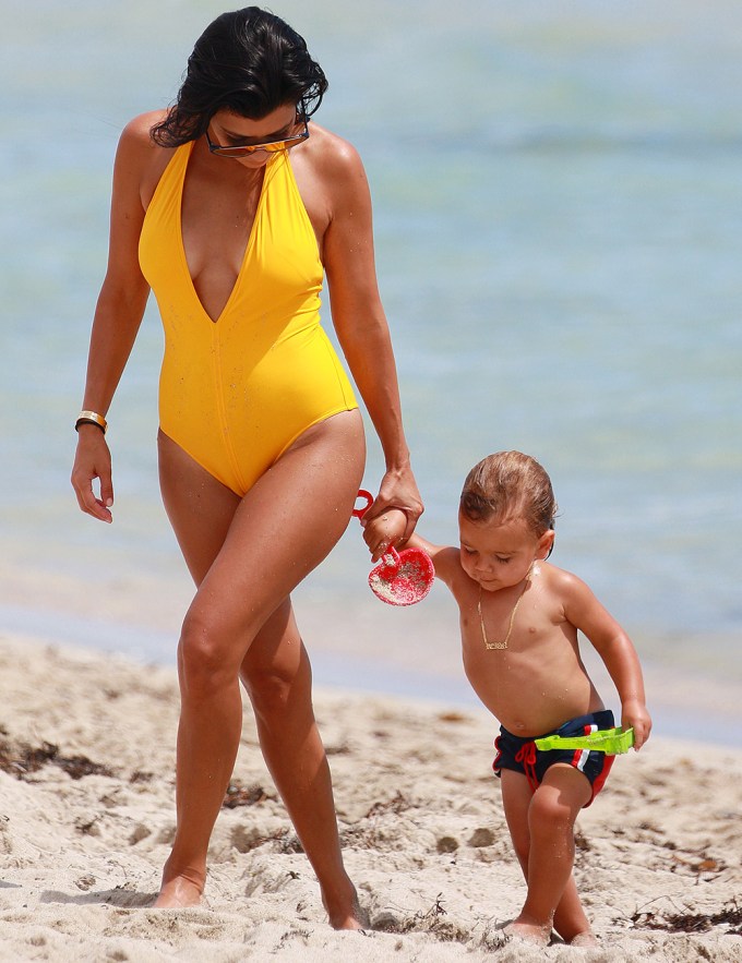 Kourtney Kardashian & Reign Disick walk on sand