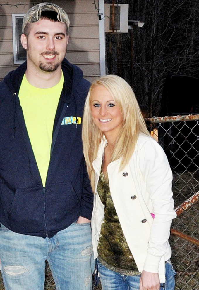 Leah Messer and Corey Simms smile in a posed photo