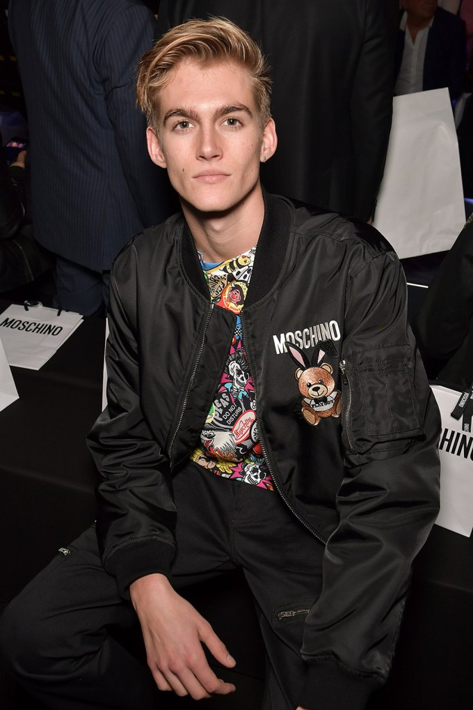 Presley Gerber sitting at the Moschino show