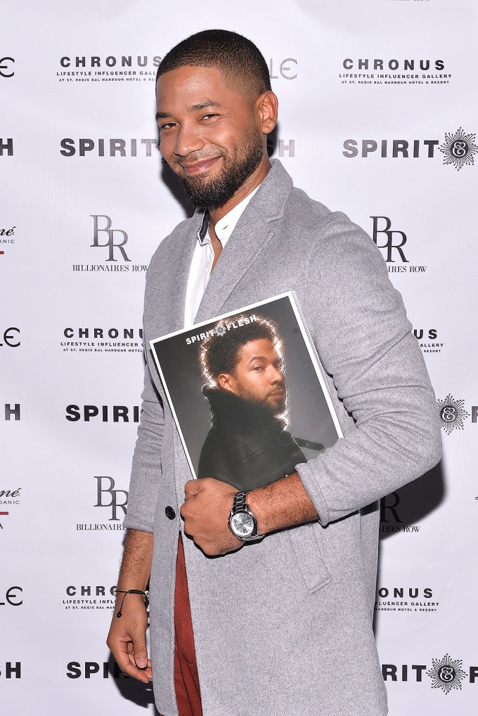 Jussie Smollett holds his copy of a magazine