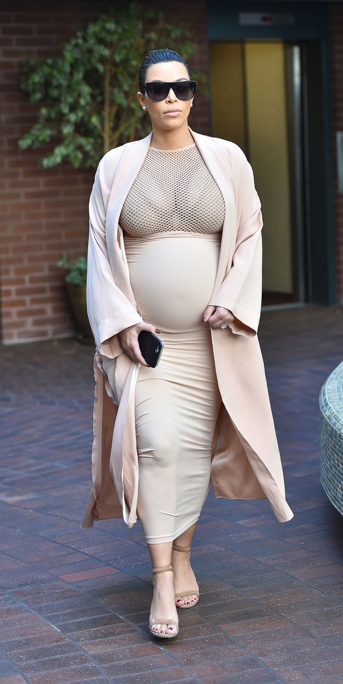 Kim Kardashian in a sheer net top while pregnant