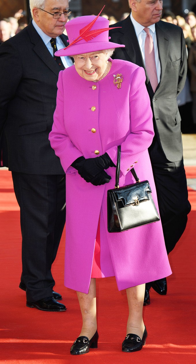 Queen Elizabeth smiling in pink
