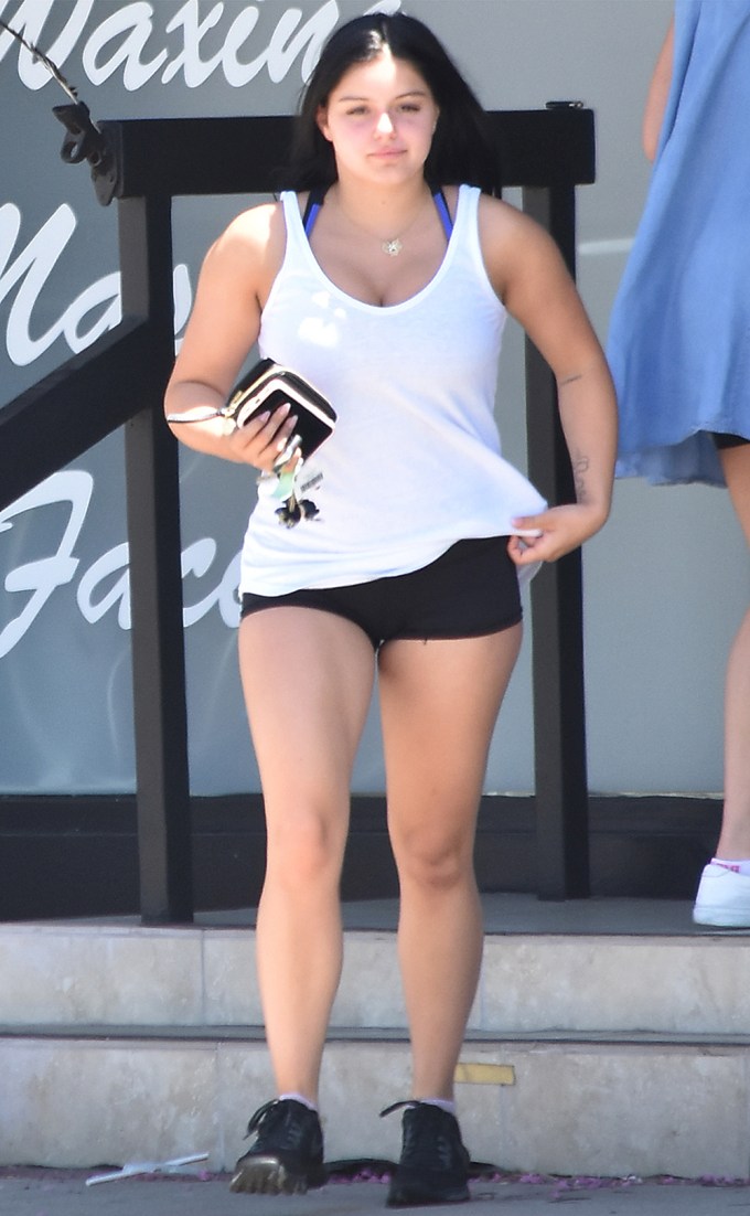 Ariel Winter wearing super short-shorts and a white tank top