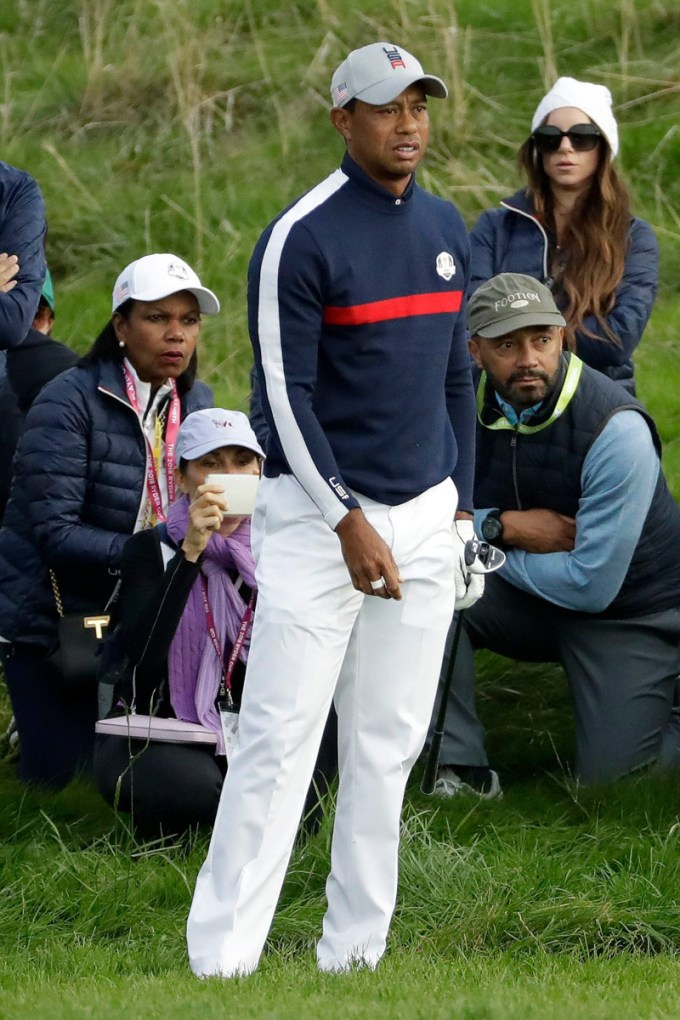 Tiger Woods & Erica Herman standing in the grass