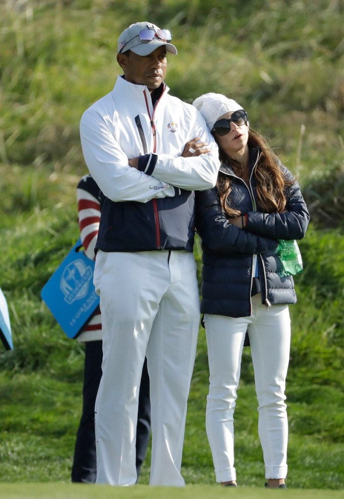 Tiger Woods & Erica Herman crossing their arms