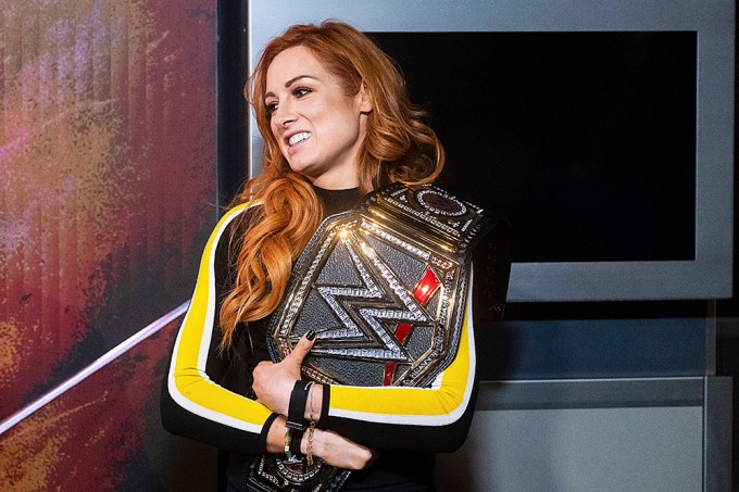 Becky Lynch holding a WWE belt