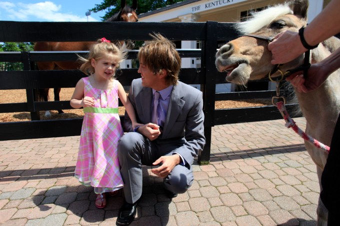 Dannielynn Birkhead and her dad look at a horse