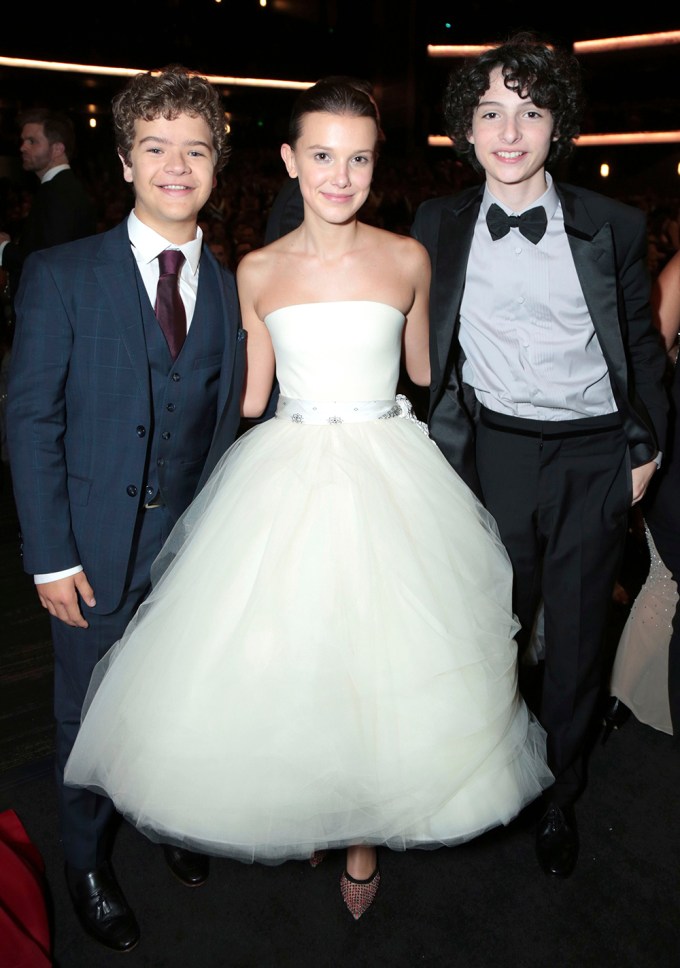 Finn Wolfhard poses with two of his co-stars