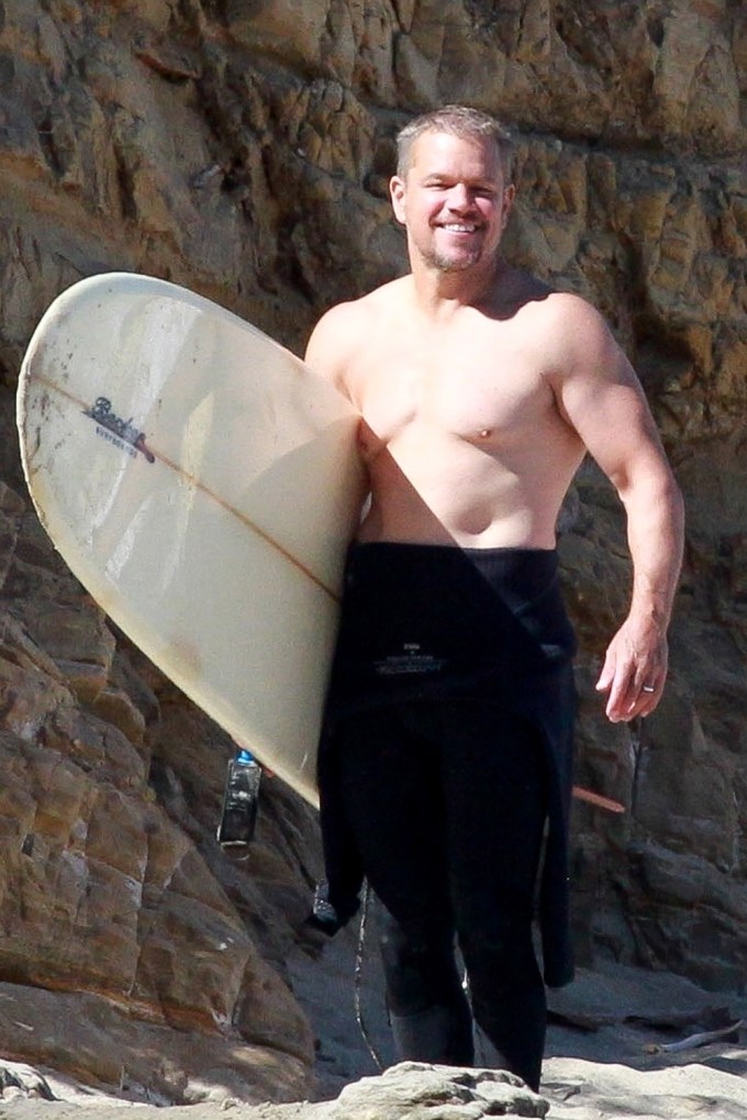 Matt Damon holding a surfboard