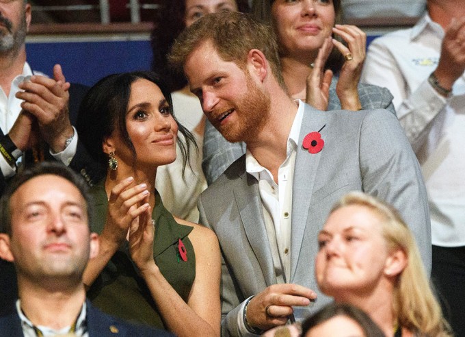 Prince Harry Whispers To Meghan Markle