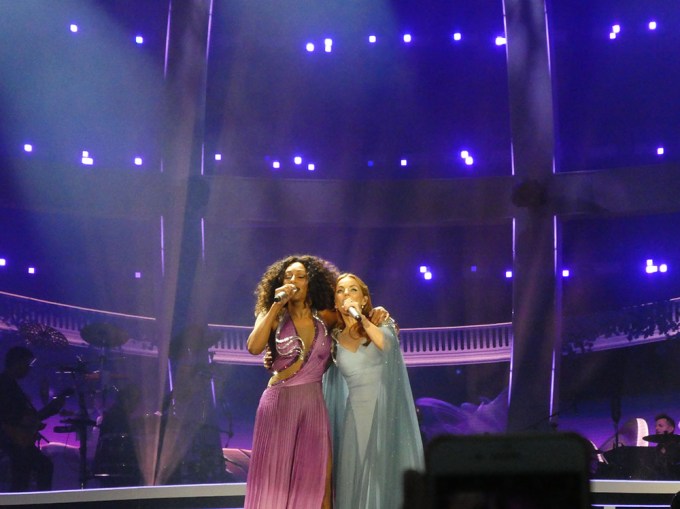 Mel B and Geri Horner hug while singing on the Spice Girls Reunion Tour
