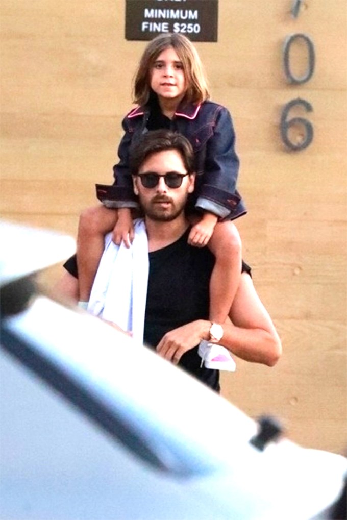 Scott Disick Carries Penelope To Their Car