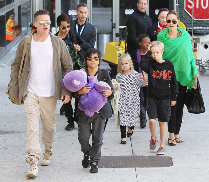 Brad Pitt walks with his family
