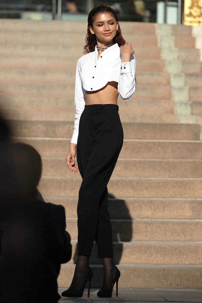 Zendaya shows abs in a white long sleeved crop top