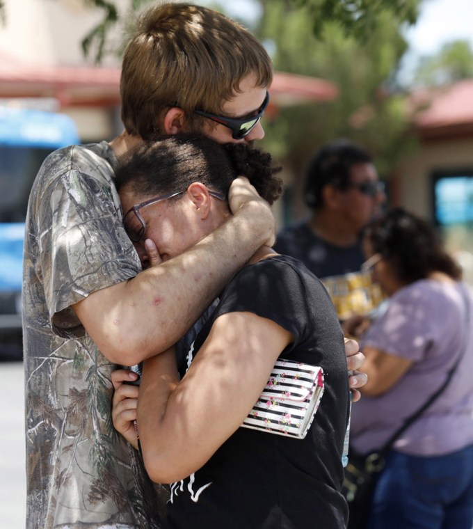 People comforting each other outside a mass shooting at Wal-Mart in El Paso