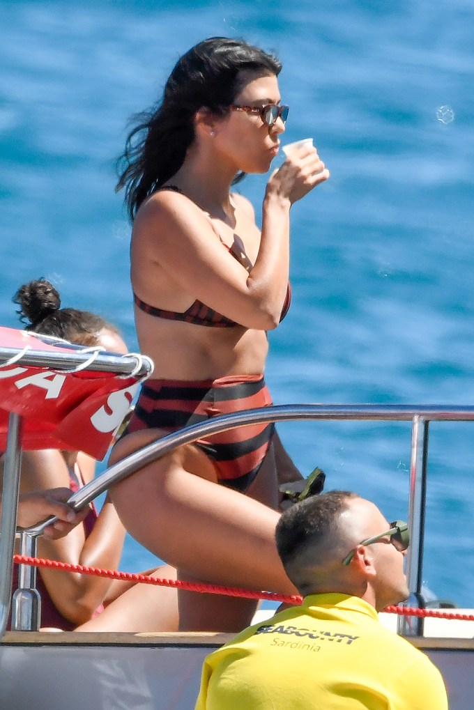 Kourtney Kardashian sipping a beverage on a yacht in Sardinia