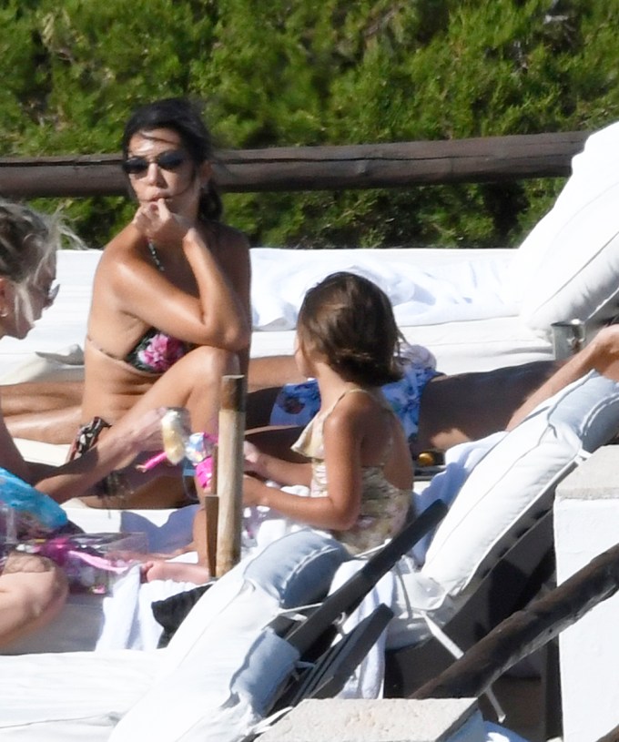 Kourtney Kardashian & daughter Penelope laying out in Sardinia