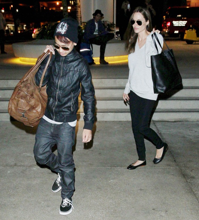 Angelina and Maddox carry luggage