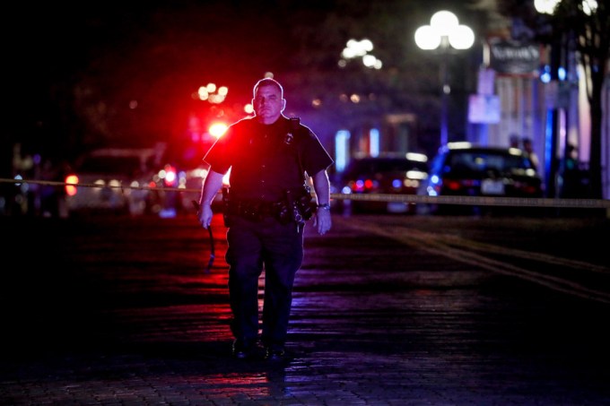 A police office walks at the scene of the Dayton, Ohio shooting