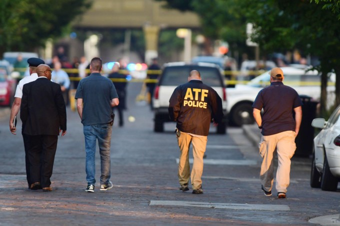 Authroities walk at the scene of a Dayton, Ohio shooting