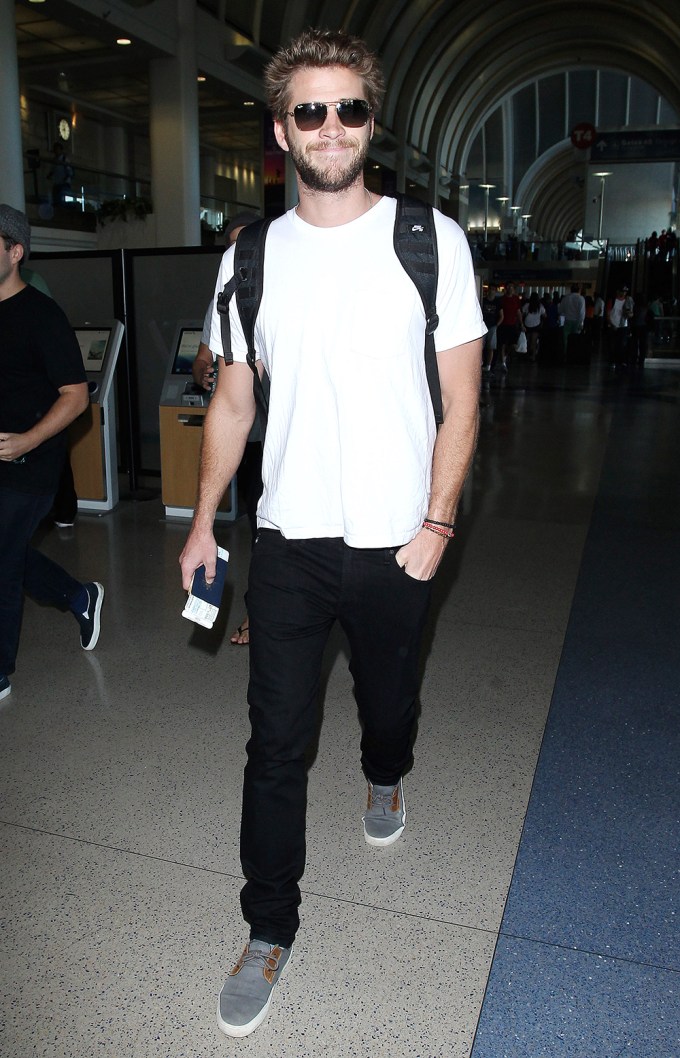 Liam Hemsworth all smiles at LAX Airport