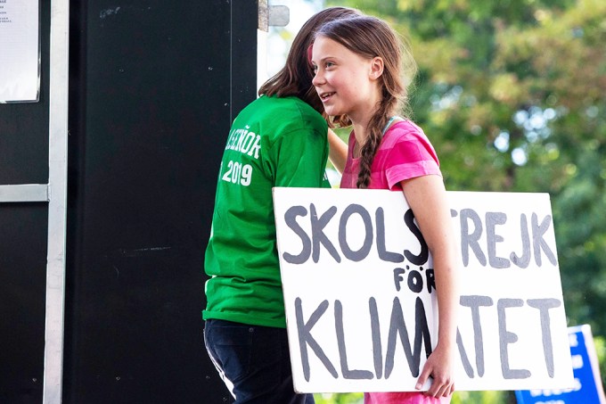 Greta Thunberg holding a sign