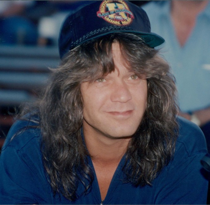 Eddie Van Halen smiles in a hat