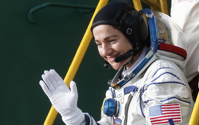 Jessica Meir waves before boarding the Soyuz MS-15 spacecraft
