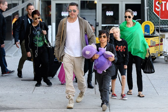 Brad Pitt & Angelina Jolie Guide Their Kids Through LAX