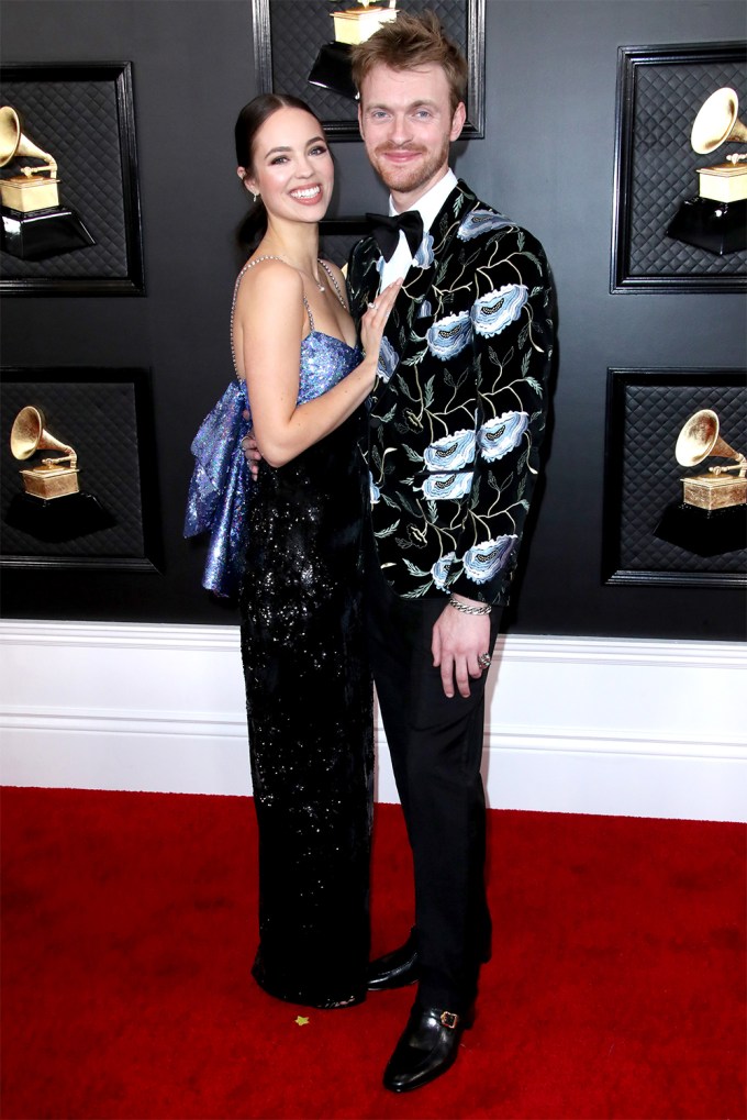 Claudia Sulewski and Finneas O’Connell pose close on the Grammys red carpet