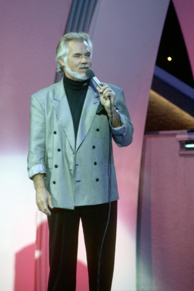Kenny Rogers speaking into a microphone
