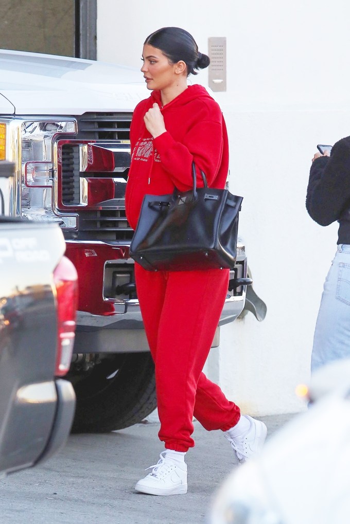 Kylie Jenner stuns in a red sweatsuit while heading to Milk Studios